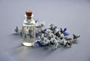 Close-up of a lavender oil bottle with dried flowers for aromatherapy. Perfect for wellness themes.